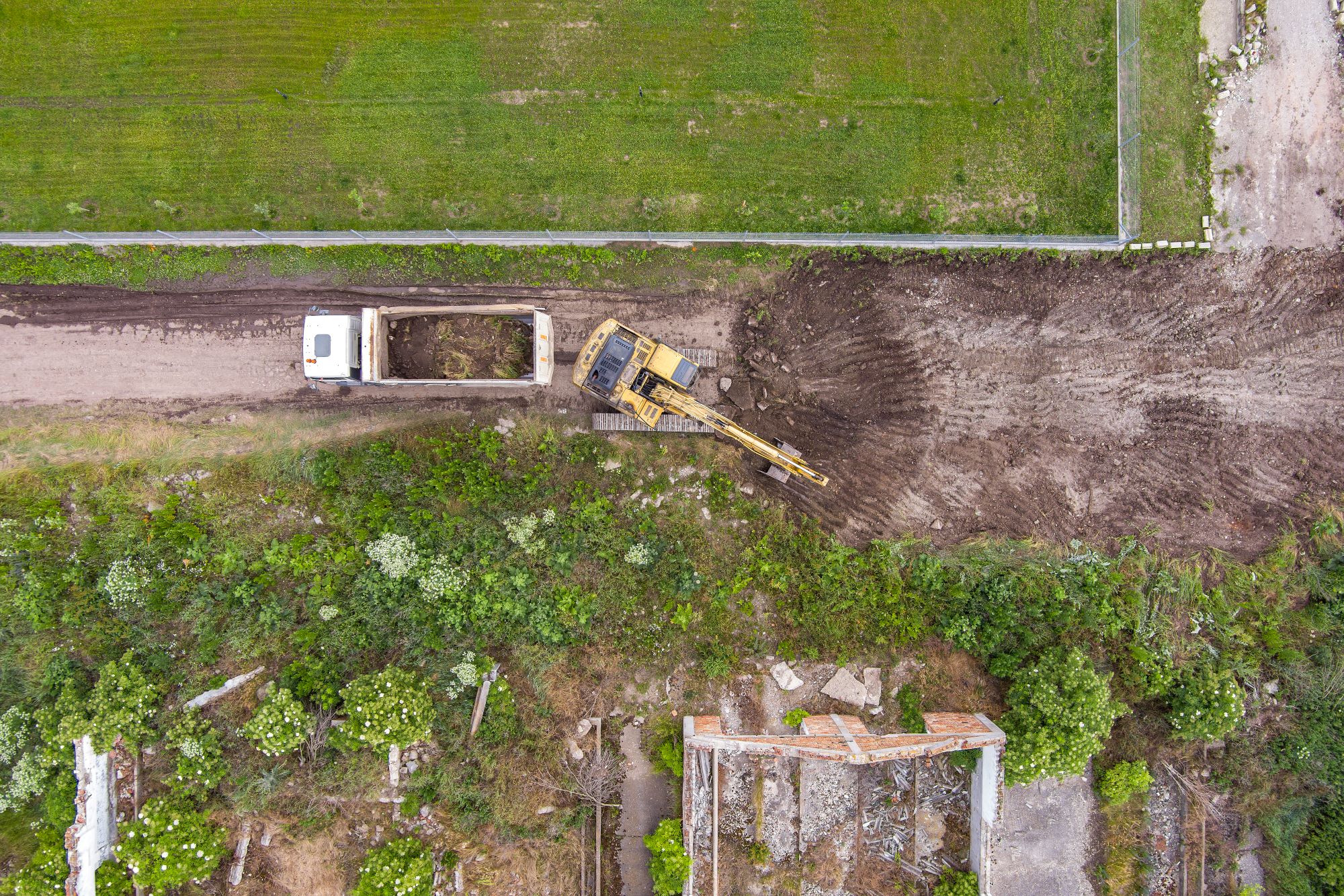 Small excavator preparing garden beds and pathways