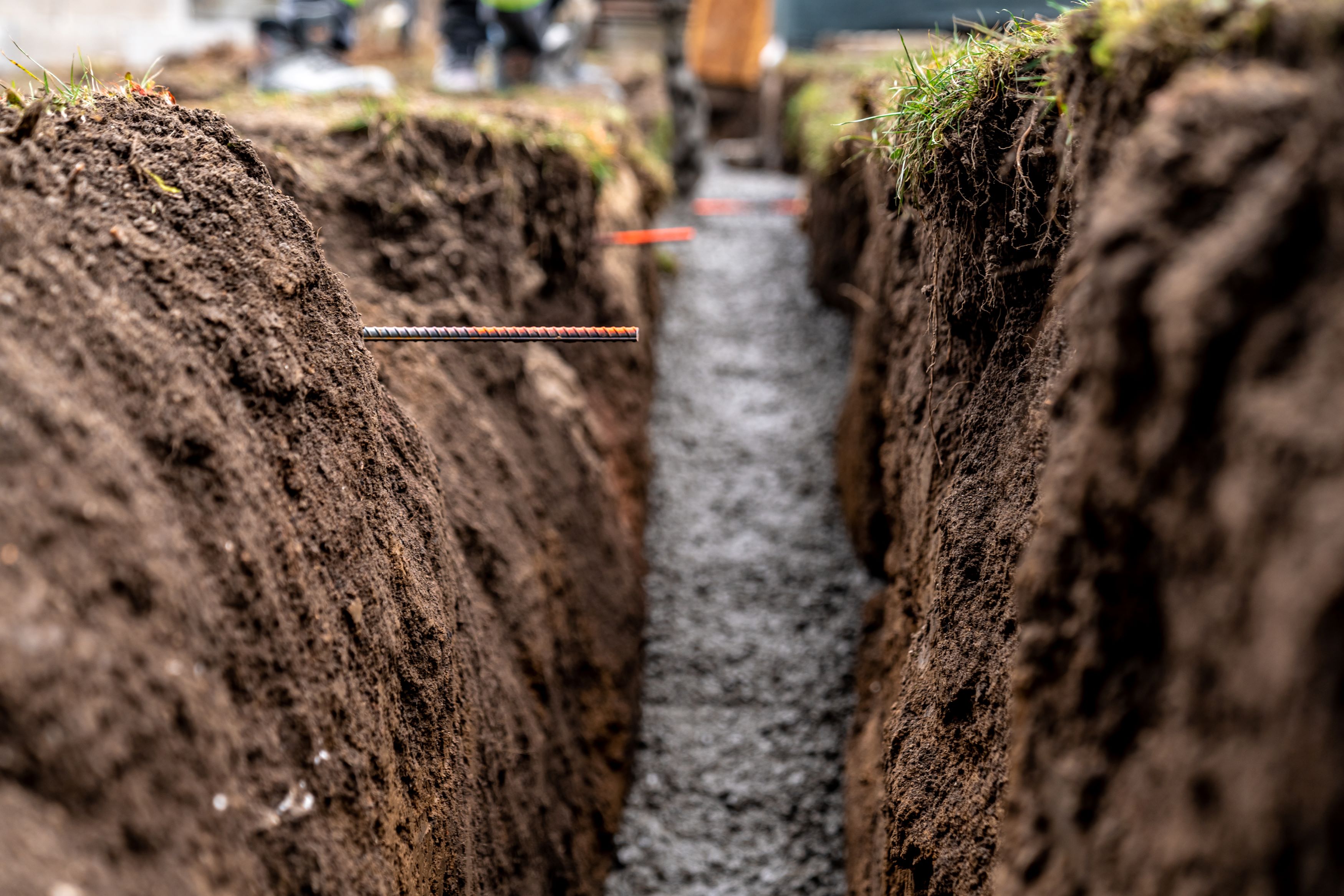 Microtrencher cutting a narrow slot for fiber conduit