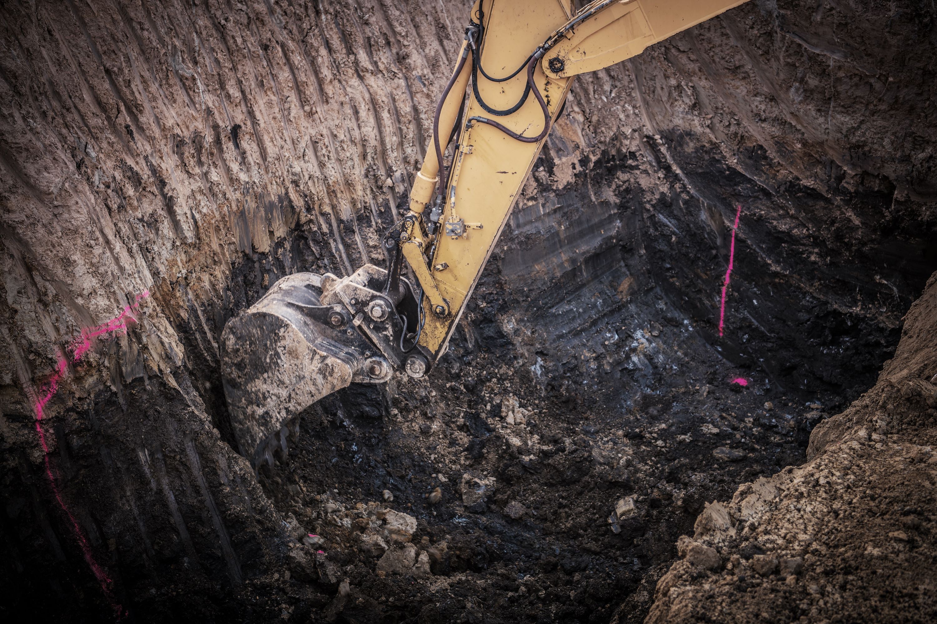 Shaping a new pond basin with an excavator