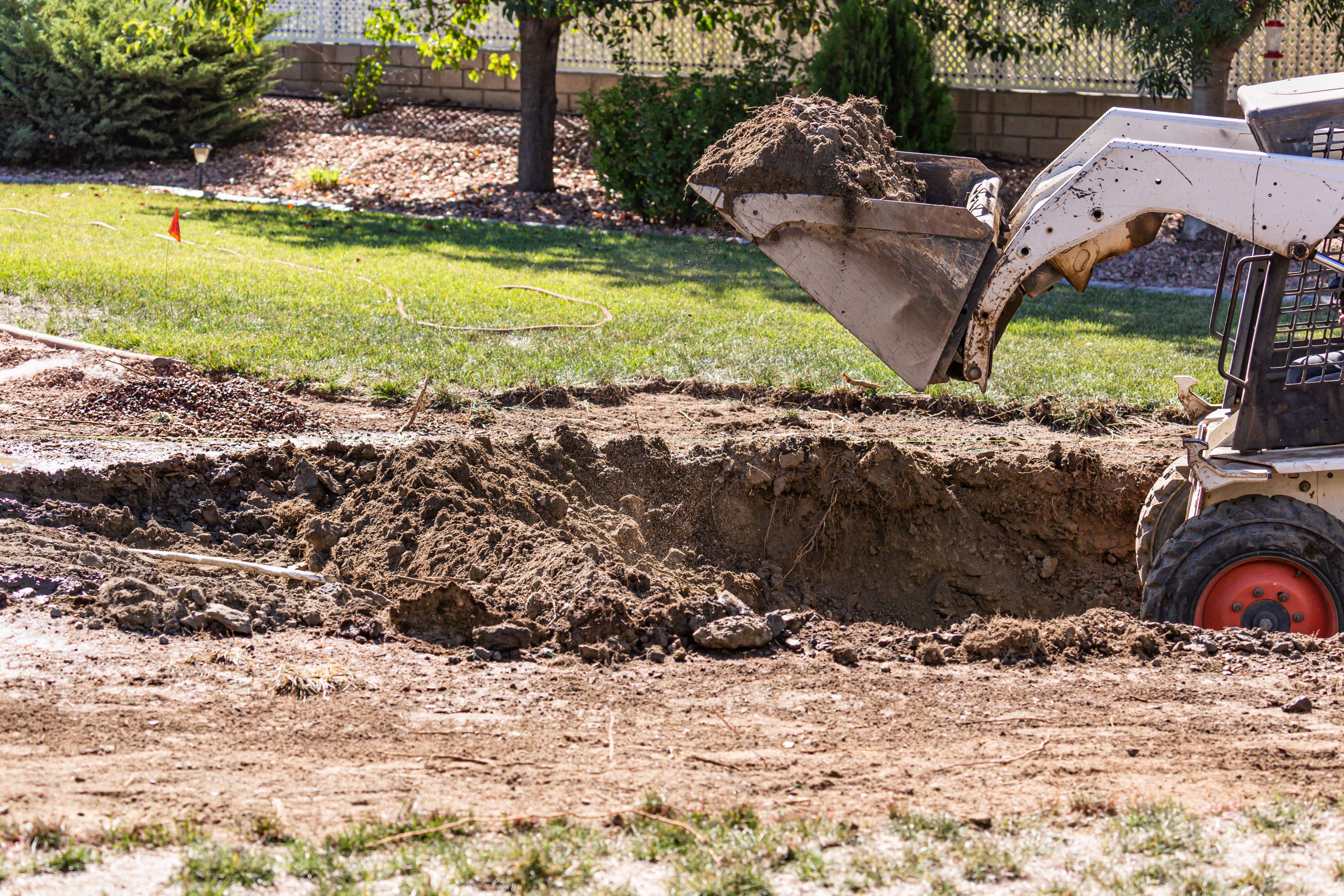 Excavation of a residential pool footprint with compact excavator